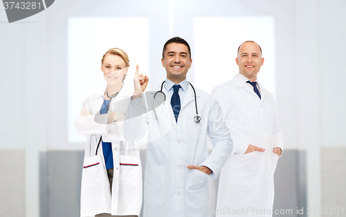 Image of group of doctors at hospital pointing finger up