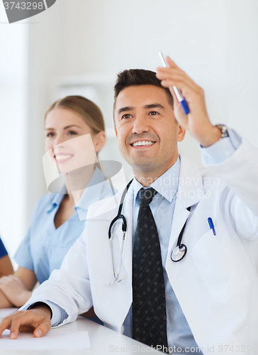 Image of group of happy doctors on conference at hospital