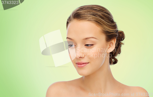 Image of smiling young woman face and shoulders over green