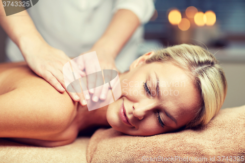 Image of close up of woman lying and having massage in spa