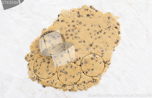 Image of Circles being cut from rolled out cookie dough 