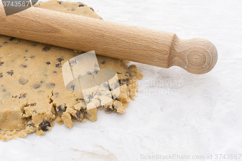 Image of Wooden rolling pin on chocolate chip shortbread dough