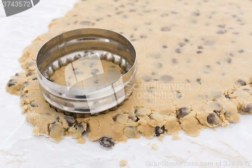 Image of Cookie cutter cutting circle from cookie dough