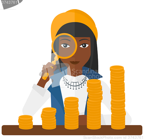 Image of Woman with magnifier and golden coins. 