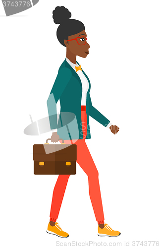 Image of Business woman walking with briefcase. 