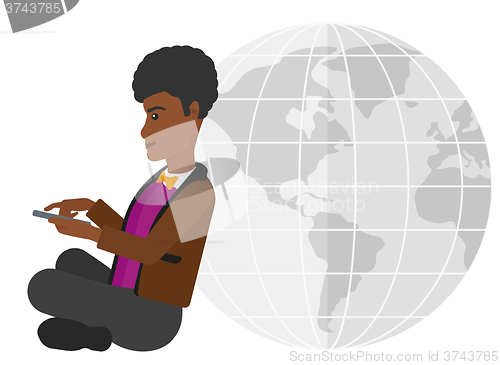 Image of Man sitting near globe.