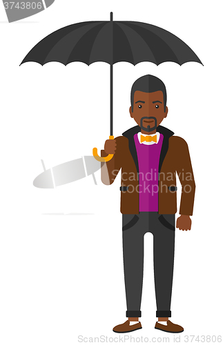 Image of Businessman standing with umbrella.