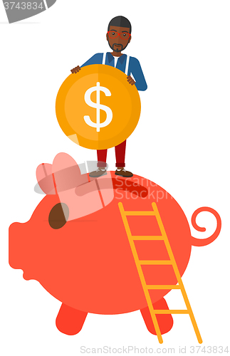 Image of Man putting coin in piggy bank.