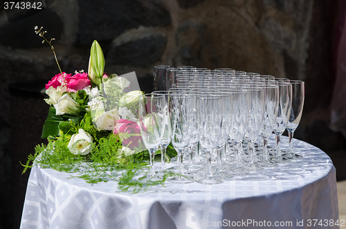 Image of Bouquet of flowers and wine glasses for a wedding table 