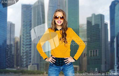 Image of happy young woman or teen girl in shades over city