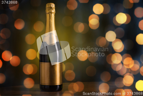 Image of bottle of champagne with blank golden label