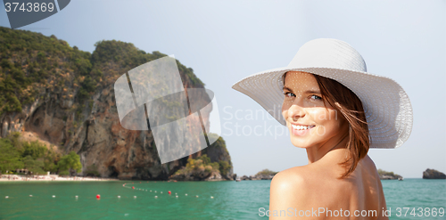 Image of happy young woman in sunhat over summer beach