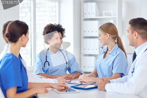 Image of group of happy doctors meeting at hospital office