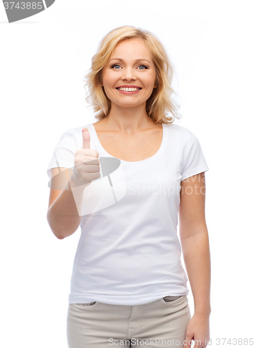 Image of smiling woman in white t-shirt showing thumbs up