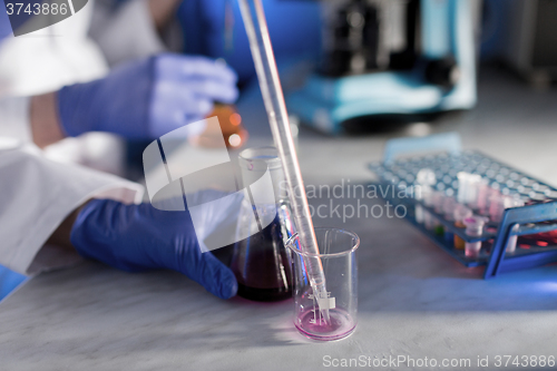 Image of close up of scientists making test in lab