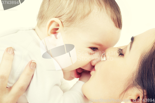 Image of mother kissing her baby