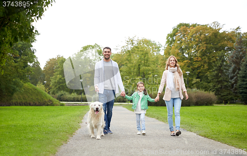 Image of happy family with labrador retriever dog in park