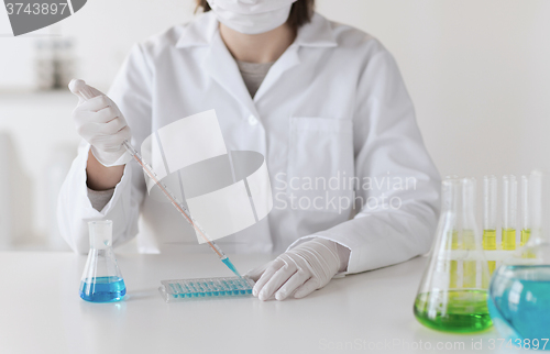 Image of close up of scientist making test in lab