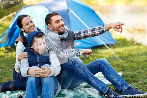 Image of happy family with tent at camp site