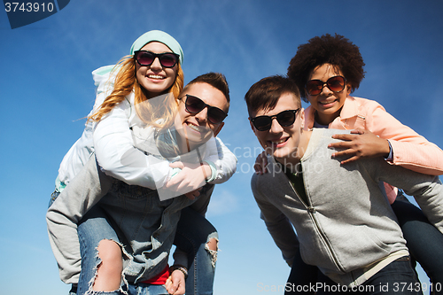 Image of happy friends in shades having fun outdoors