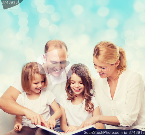 Image of happy family with book at home