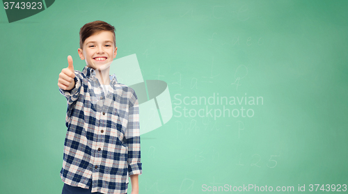 Image of smiling boy in checkered shirt showing thumbs up