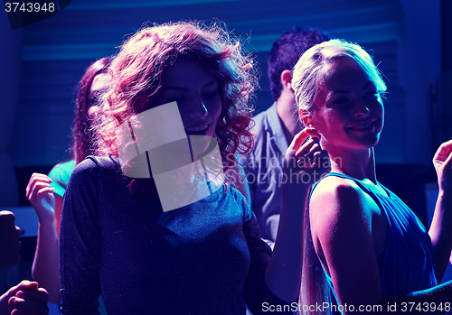 Image of group of happy friends dancing in night club