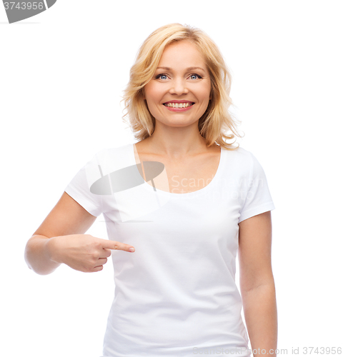 Image of smiling woman in white t-shirt pointing to herself