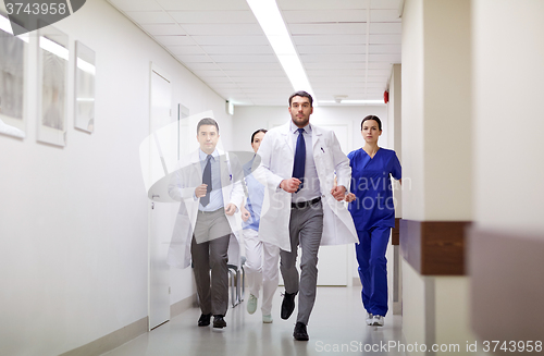 Image of group of medics walking along hospital