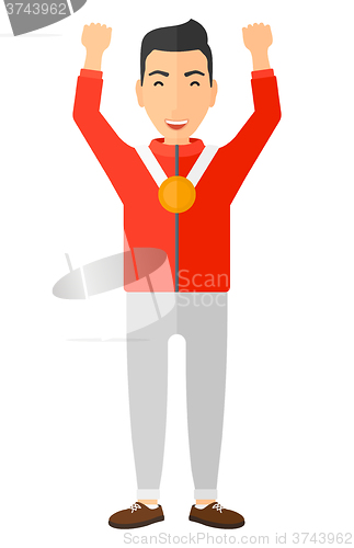 Image of Athlete with medal and hands raised.