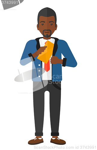 Image of Man putting envelope in pocket.