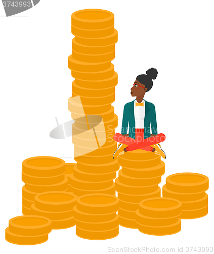 Image of Business woman sitting on gold.