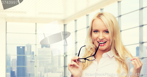 Image of smiling businesswoman or secretary in office