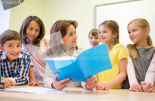 Image of group of school kids with teacher in classroom