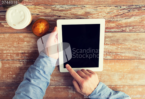 Image of close up of male hands with tablet pc and coffee
