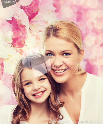 Image of smiling mother and little girl