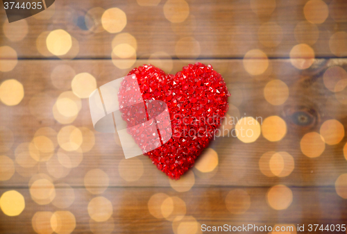 Image of close up of red heart decoration on wood