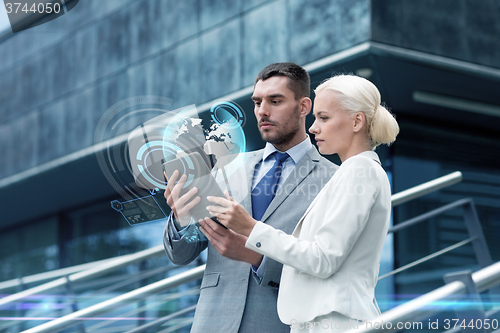 Image of businesspeople with tablet pc outdoors