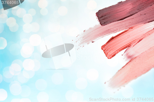 Image of close up of lipstick smear sample over blue lights