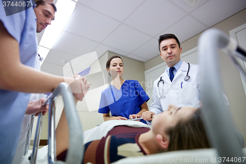 Image of medics and patient on hospital gurney at emergency