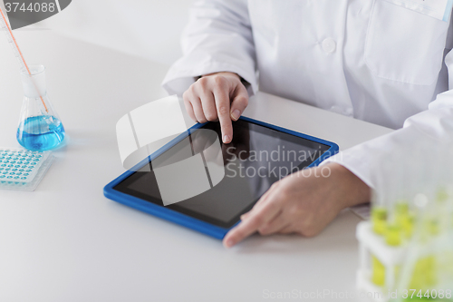 Image of close up of scientist with tablet pc in lab