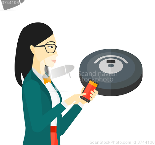 Image of Woman with robot vacuum cleaner.