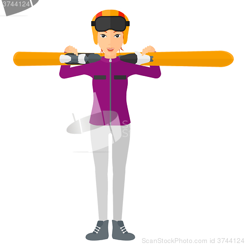 Image of Woman holding skis.