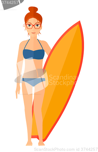 Image of Surfer holding surfboard.