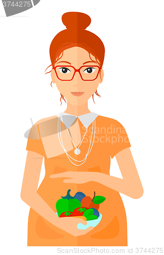 Image of Pregnant woman with vegetables.