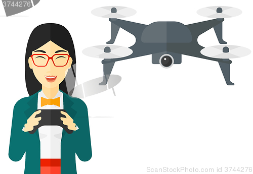 Image of Woman flying drone.