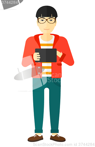Image of Man using tablet computer.