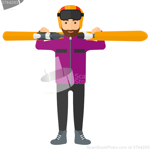 Image of Man holding skis.