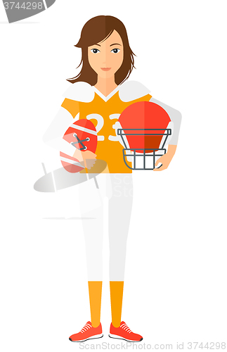 Image of Rugby player with ball and helmet in hands.