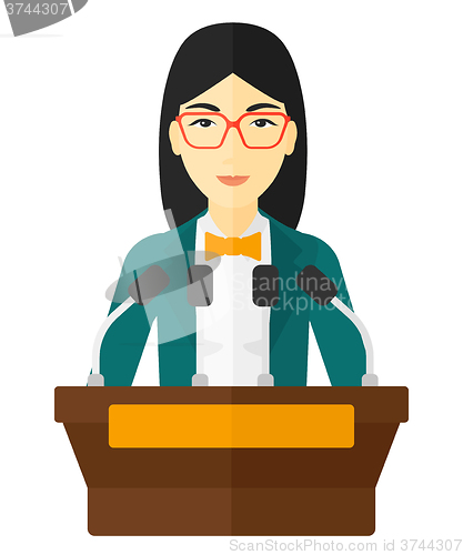 Image of Woman speaking on podium.